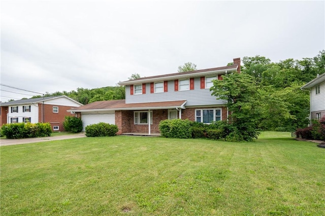 206 Bonnie St, Rostraver, PA 15012 - view of front facade with a chimney, an attached garage, brick siding, and a front yard