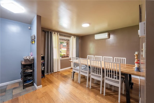 206 Bonnie St, Rostraver, PA 15012 - dining area with a wall unit AC and light wood finished floors