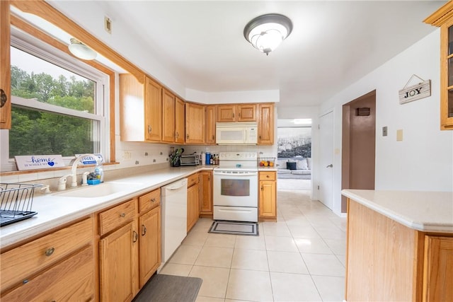 206 Bonnie St, Rostraver, PA 15012 - kitchen with white appliances, decorative backsplash, light tile patterned floors, and light countertops