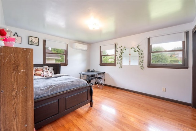 206 Bonnie St, Rostraver, PA 15012 - bedroom with an AC wall unit and light wood-type flooring