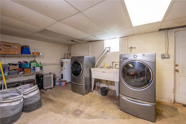 206 Bonnie St, Rostraver, PA 15012 - laundry room featuring water heater, concrete block wall, and washer and clothes dryer