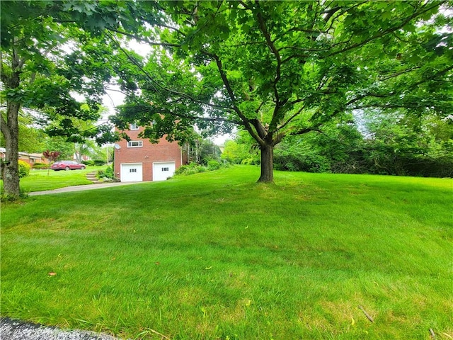 1176 Colgate Dr, Monroeville, PA 15146 - view of green lawn with an attached garage and driveway