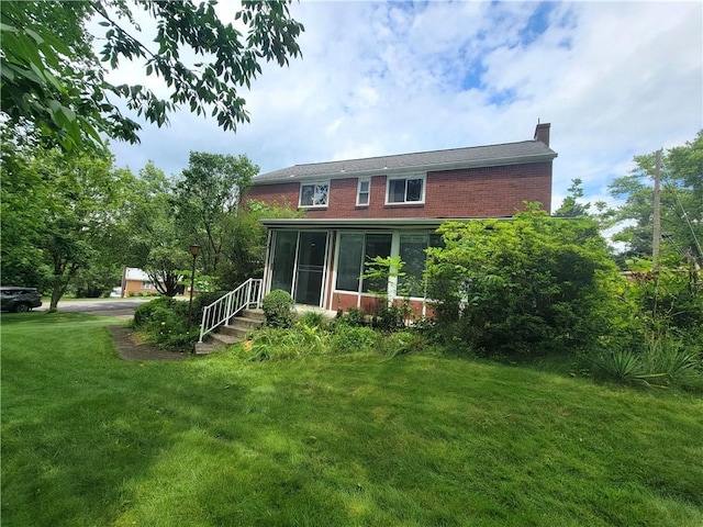 1176 Colgate Dr, Monroeville, PA 15146 - rear view of property with brick siding, a chimney, a yard, and a sunroom
