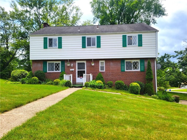 1176 Colgate Dr, Monroeville, PA 15146 - view of front of property with brick siding, a front yard, and a chimney