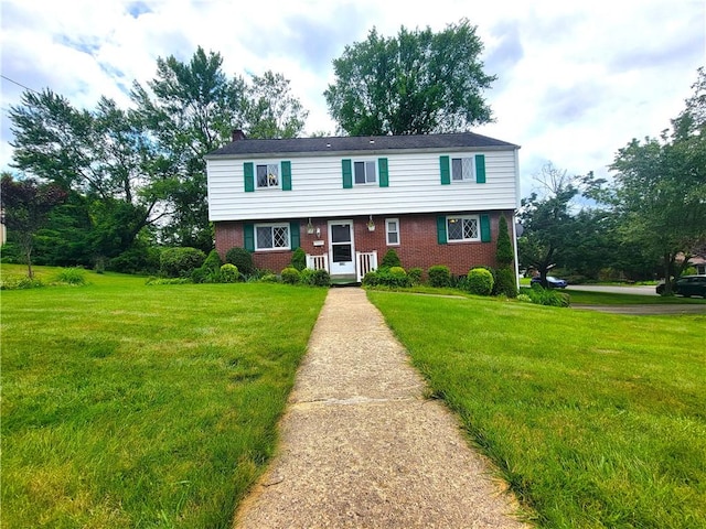 1176 Colgate Dr, Monroeville, PA 15146 - view of front facade featuring brick siding, a front lawn, and a chimney