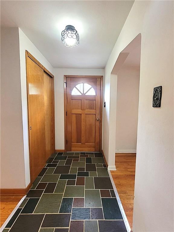 1176 Colgate Dr, Monroeville, PA 15146 - doorway with baseboards and dark wood-style flooring