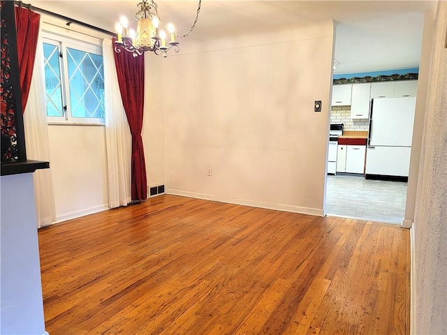 1176 Colgate Dr, Monroeville, PA 15146 - unfurnished dining area featuring a chandelier and wood finished floors