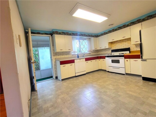 1176 Colgate Dr, Monroeville, PA 15146 - kitchen with white appliances, backsplash, and white cabinets