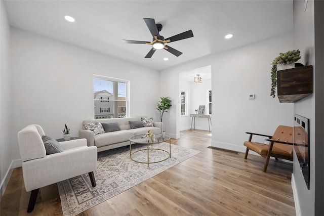 141 Blackhawk St, Squirrel Hill, PA 15218 - living room with light wood-type flooring, ceiling fan, recessed lighting, and a glass covered fireplace