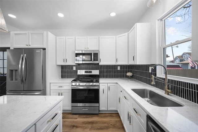 141 Blackhawk St, Squirrel Hill, PA 15218 - kitchen featuring appliances with stainless steel finishes, backsplash, white cabinets, light stone counters, and dark wood-type flooring