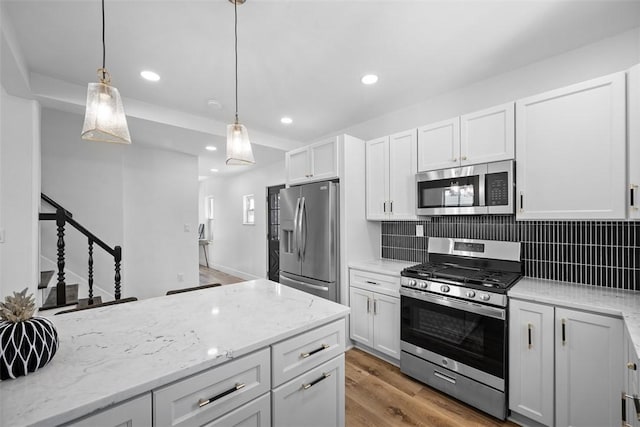 141 Blackhawk St, Squirrel Hill, PA 15218 - kitchen featuring stainless steel appliances, decorative backsplash, light wood-type flooring, recessed lighting, and hanging light fixtures