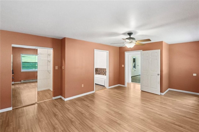 222 Lear Rd, Blairsville Area, PA 15717 - unfurnished bedroom with baseboard heating, light wood-style floors, a ceiling fan, and connected bathroom