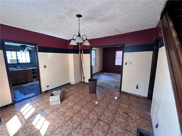 302 Franklin Ave, Applewold, PA 16201 - unfurnished dining area with a chandelier, plenty of natural light, and a textured ceiling