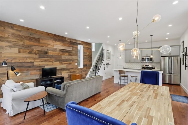 3130 Dobson St, Polish Hill, PA 15219 - living area featuring stairway, wood walls, recessed lighting, and wood finished floors