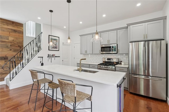 3130 Dobson St, Polish Hill, PA 15219 - kitchen with stainless steel appliances, gray cabinetry, tasteful backsplash, dark wood finished floors, and recessed lighting