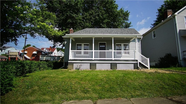 801 9th Ave, Brackenridge, PA 15014 - view of front of house with covered porch, a front lawn, a chimney, and a shingled roof