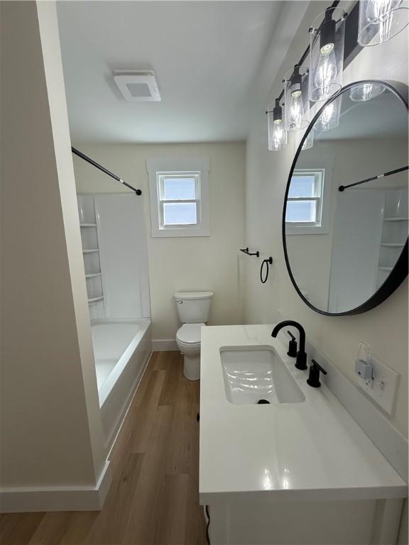 801 9th Ave, Brackenridge, PA 15014 - full bathroom with healthy amount of natural light, vanity, wood finished floors, and bathtub / shower combination