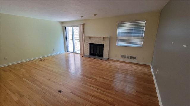 402 Forest Ridge Dr, Forest Hills Boro, PA 15221 - unfurnished living room featuring light wood-style flooring and a brick fireplace