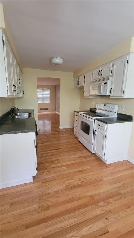 402 Forest Ridge Dr, Forest Hills Boro, PA 15221 - kitchen featuring white appliances, dark countertops, white cabinets, and light wood-style floors