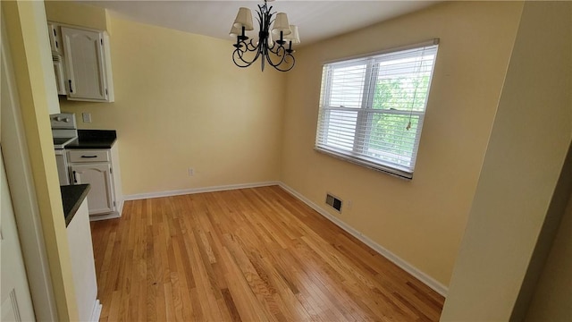 402 Forest Ridge Dr, Forest Hills Boro, PA 15221 - unfurnished dining area featuring a chandelier and light wood-style floors