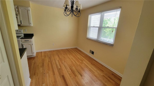 402 Forest Ridge Dr, Forest Hills Boro, PA 15221 - unfurnished dining area featuring a chandelier and light wood-style floors