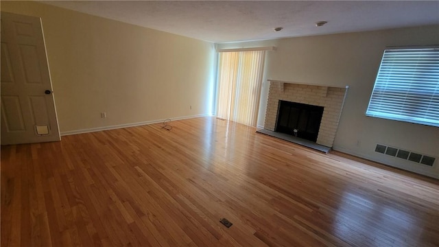 402 Forest Ridge Dr, Forest Hills Boro, PA 15221 - unfurnished living room with wood finished floors and a brick fireplace