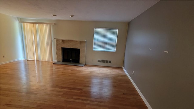 402 Forest Ridge Dr, Forest Hills Boro, PA 15221 - unfurnished living room featuring wood finished floors and a brick fireplace