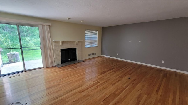 402 Forest Ridge Dr, Forest Hills Boro, PA 15221 - unfurnished living room with light wood finished floors and a brick fireplace