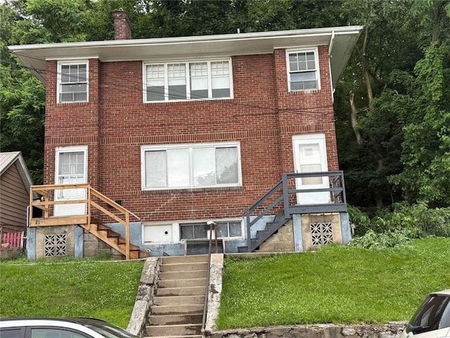 25-27 Joel St, Ingram, PA 15205 - view of front of house with stairs, brick siding, a front yard, and a chimney