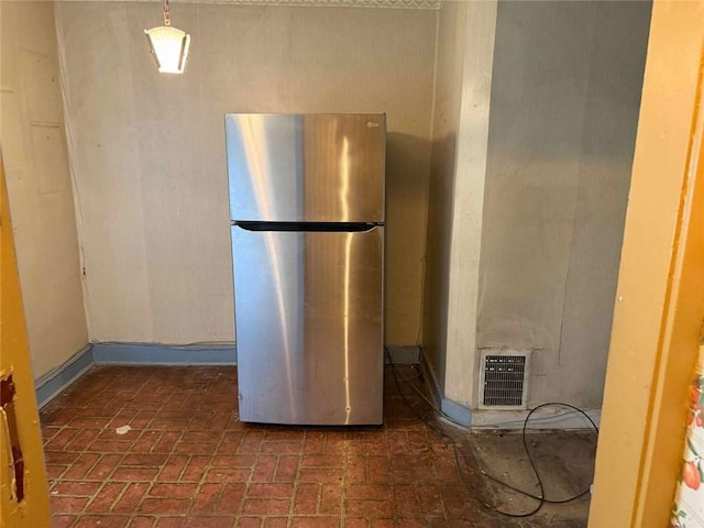 25-27 Joel St, Ingram, PA 15205 - kitchen featuring freestanding refrigerator and brick patterned flooring