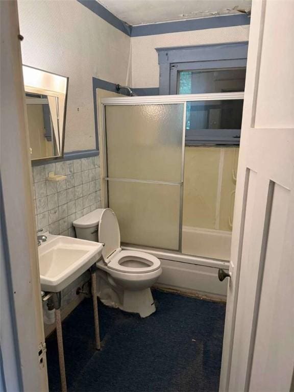 25-27 Joel St, Ingram, PA 15205 - full bath featuring tile walls, bath / shower combo with glass door, and wainscoting