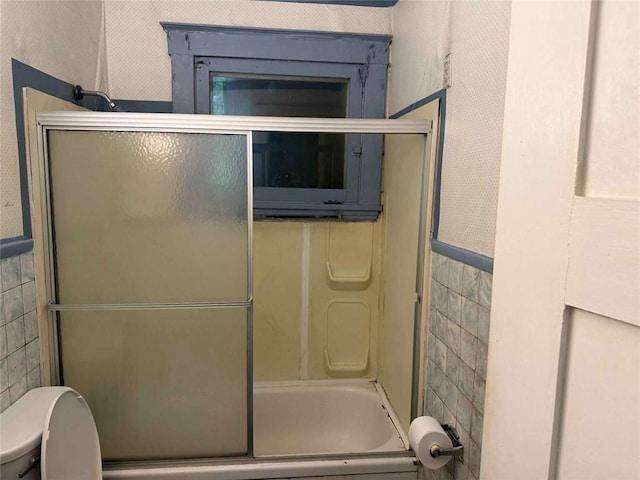 25-27 Joel St, Ingram, PA 15205 - bathroom with tile walls and bath / shower combo with glass door