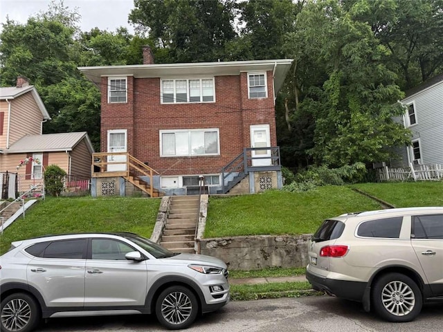 25-27 Joel St, Ingram, PA 15205 - view of front of house featuring stairway, brick siding, and a front yard