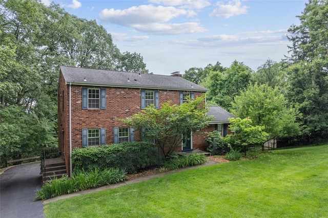 195 Grandview Dr N, Fox Chapel, PA 15215 - view of front of home with a chimney, a front lawn, brick siding, and asphalt driveway