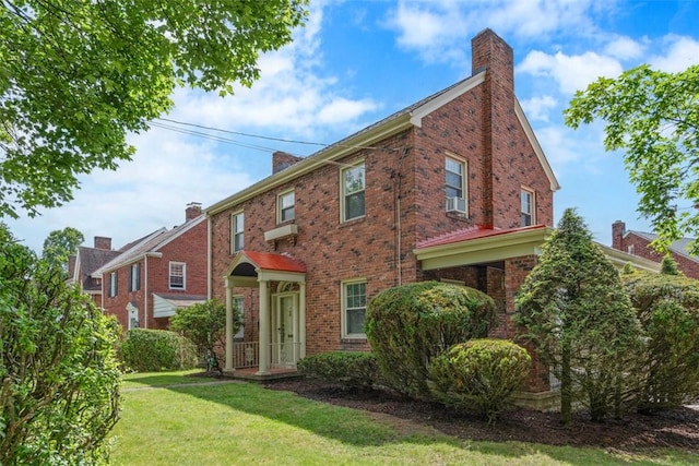 148 Stanton Ct E, Stanton Heights, PA 15201 - view of front of home featuring a chimney, a front lawn, and brick siding