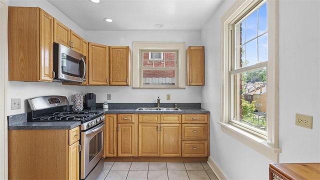 148 Stanton Ct E, Stanton Heights, PA 15201 - kitchen with appliances with stainless steel finishes, dark countertops, light tile patterned floors, recessed lighting, and brown cabinets