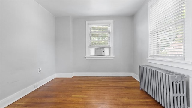 148 Stanton Ct E, Stanton Heights, PA 15201 - spare room with radiator heating unit, wood finished floors, and cooling unit