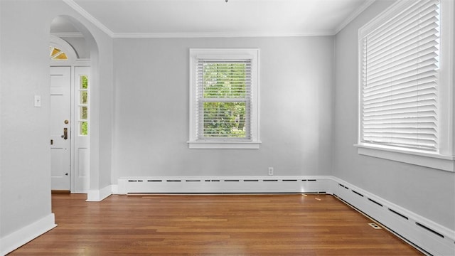 148 Stanton Ct E, Stanton Heights, PA 15201 - empty room featuring wood finished floors, crown molding, arched walkways, and a baseboard heating unit