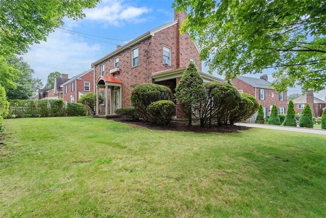 148 Stanton Ct E, Stanton Heights, PA 15201 - view of front of house featuring brick siding, a front yard, a chimney, and a residential view
