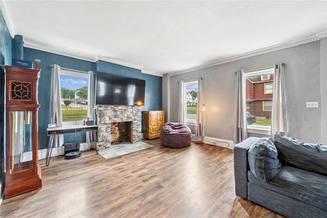 528 Spring St, Latrobe, PA 15650 - living area featuring ornamental molding, healthy amount of natural light, wood finished floors, and a stone fireplace