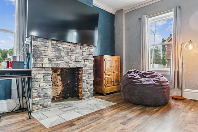 528 Spring St, Latrobe, PA 15650 - living area featuring a fireplace, a textured wall, wood finished floors, and ornamental molding