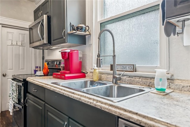 528 Spring St, Latrobe, PA 15650 - kitchen with appliances with stainless steel finishes, light countertops, and dark wood-style flooring