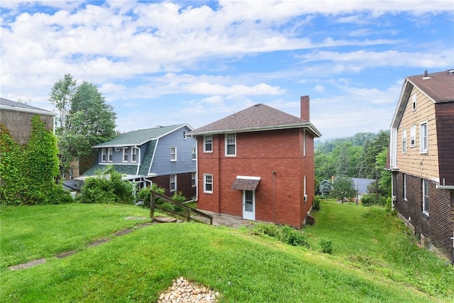 349 Avenue E Ave E, Forest Hills Boro, PA 15221 - back of property with a chimney, brick siding, and a lawn