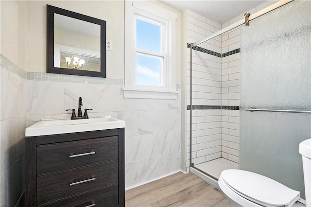 39 Danvers Ave, Ingram, PA 15205 - full bath featuring tile walls, a stall shower, vanity, wood finished floors, and a wainscoted wall