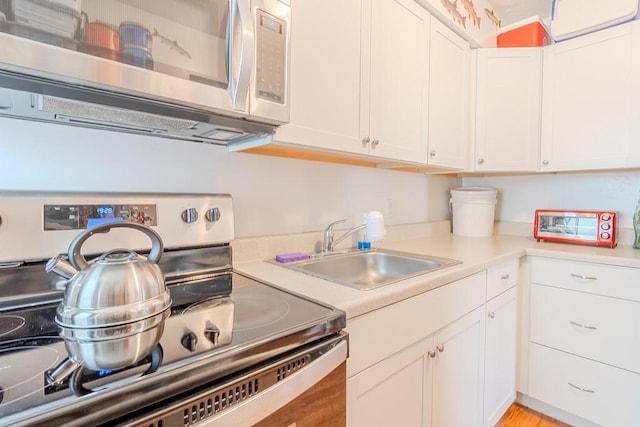 5801 Lincoln Ave, Export, PA 15632 - kitchen featuring stainless steel appliances, white cabinetry, and light countertops