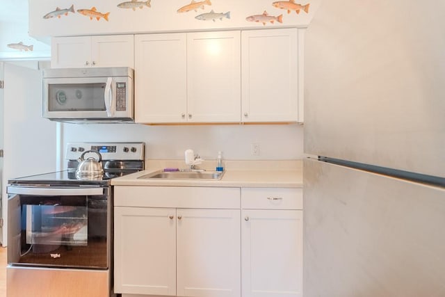 5801 Lincoln Ave, Export, PA 15632 - kitchen with stainless steel appliances, white cabinets, and light countertops