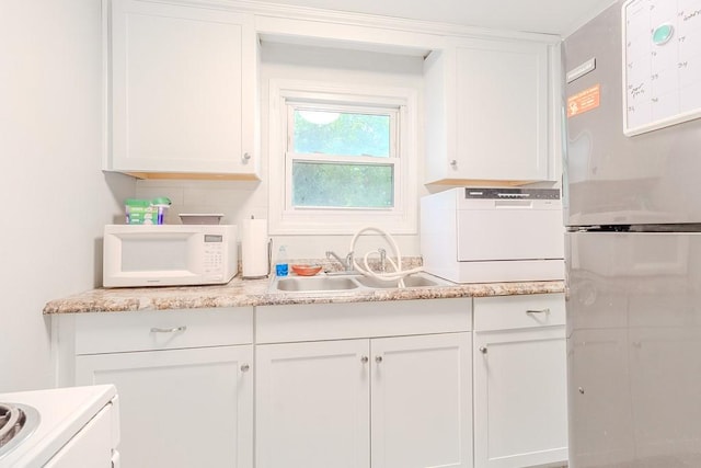 5801 Lincoln Ave, Export, PA 15632 - kitchen with freestanding refrigerator, white microwave, white cabinetry, light countertops, and stove