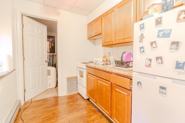5801 Lincoln Ave, Export, PA 15632 - kitchen featuring white appliances, a baseboard heating unit, light countertops, a drop ceiling, and light wood-style floors