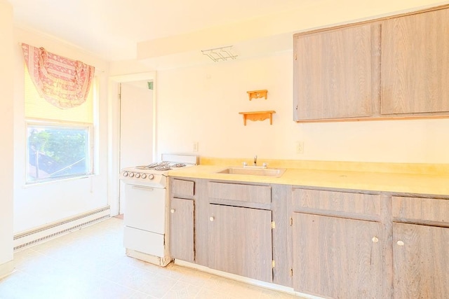 5801 Lincoln Ave, Export, PA 15632 - kitchen with baseboard heating, light countertops, light brown cabinets, white range, and light tile patterned floors