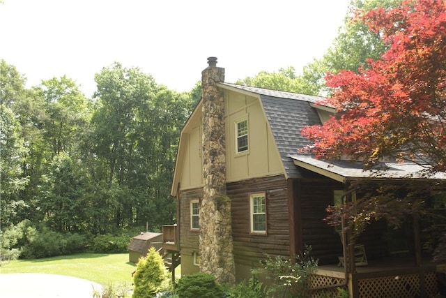 130 Hall Rd, Findley Twp, PA 16137 - view of side of property with a gambrel roof, a wooden deck, roof with shingles, a yard, and a chimney